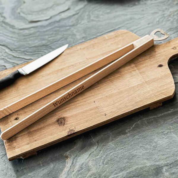 Stofftiger Grillzange mit Flaschenöffner, Holzzange mit graviertem Wunschnamen auf einem Schneidbrett